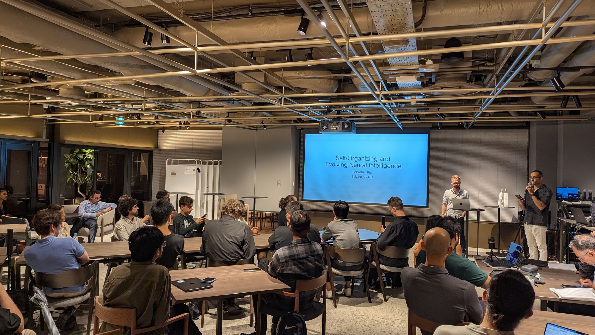Speaker and audience at the Tokyo AI TAI AAI #12 - Evolutionary Algorithms event.