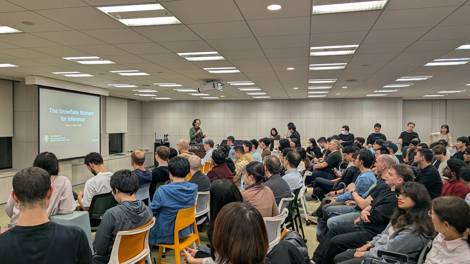 Speaker presentation and audience at A vLLM Deep Dive - Distributed Inference, KV Cache Evolution, and Model Compression.