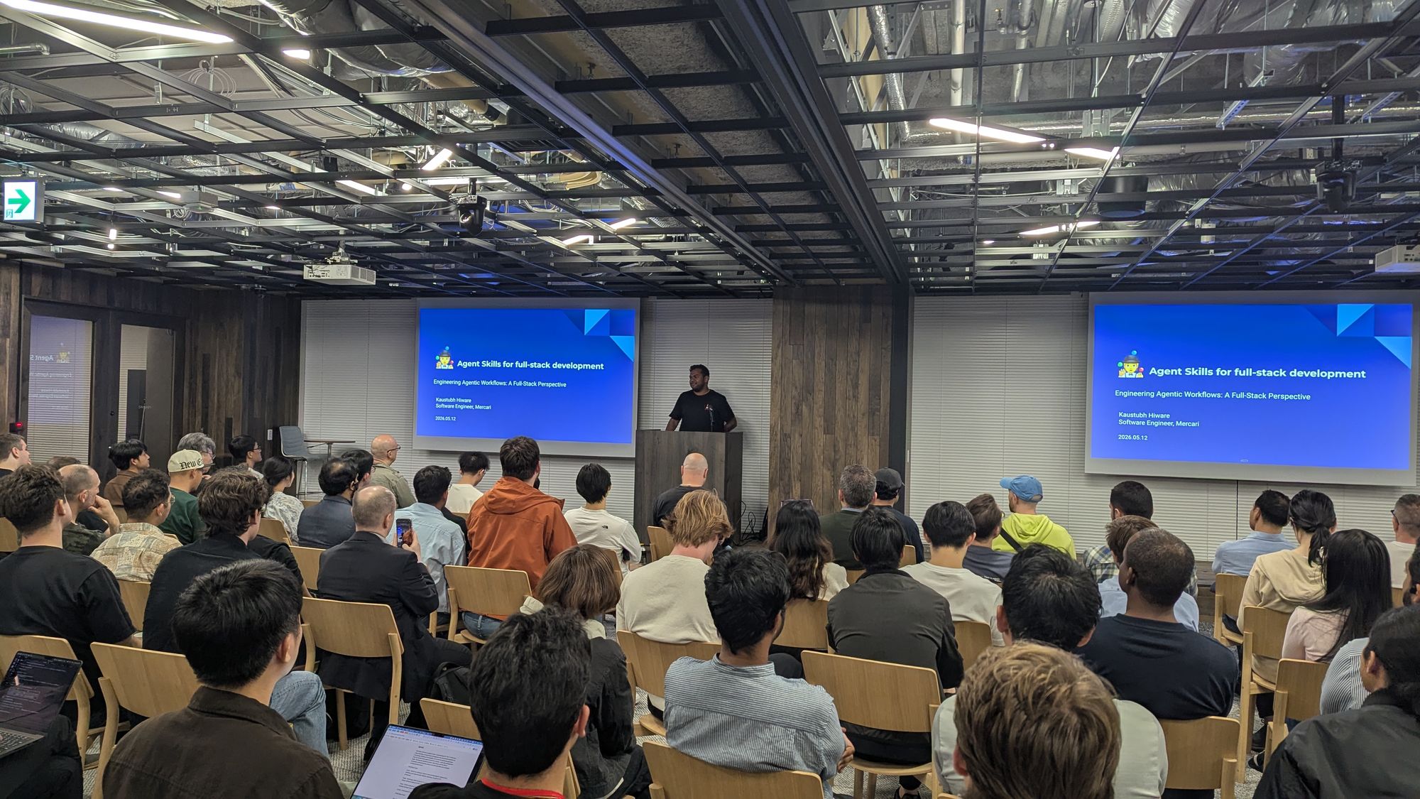 Speaker presentation and audience at Engineering Agentic Workflows - A Full-Stack Perspective.