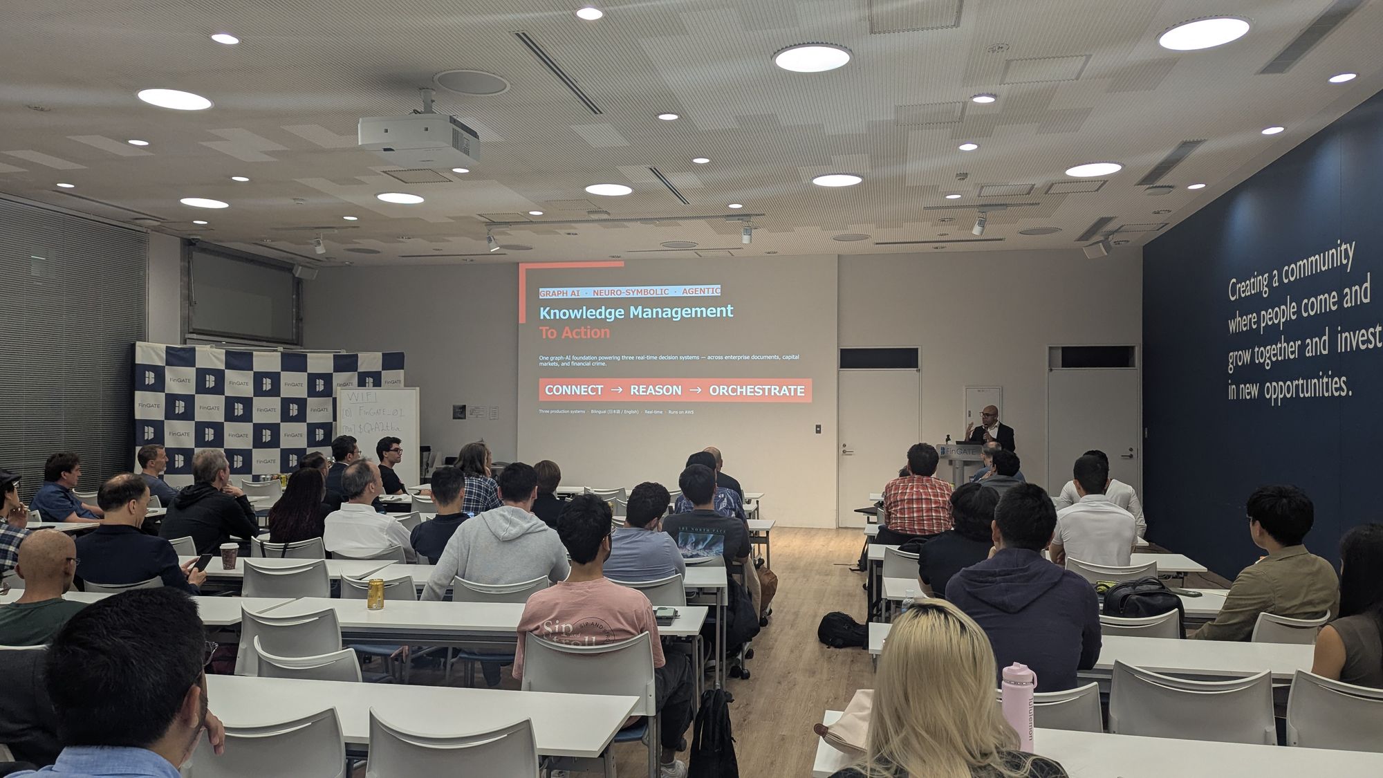 Speaker presentation and audience at AI in Financial Services - From LLM Failure Modes to Graph-Based Fraud Detection.